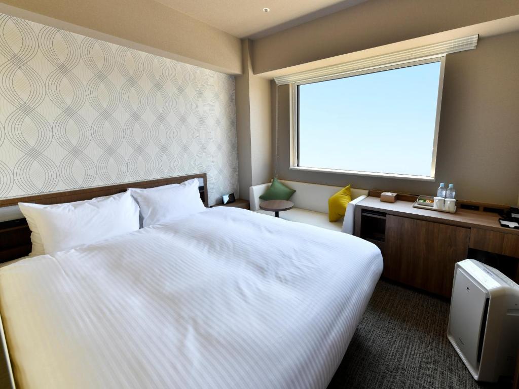 Postel nebo postele na pokoji v ubytování Wakoshi Tobu Hotel