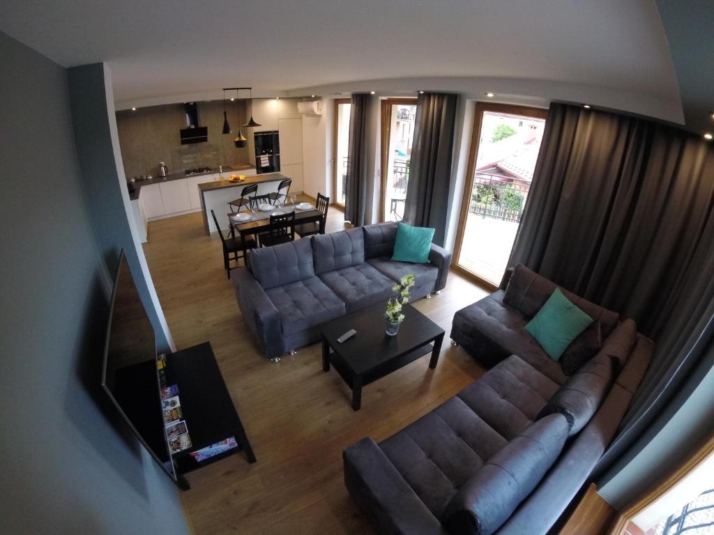 an overhead view of a living room with a couch and a table at Apartamenty Pod Jesionem in Zator