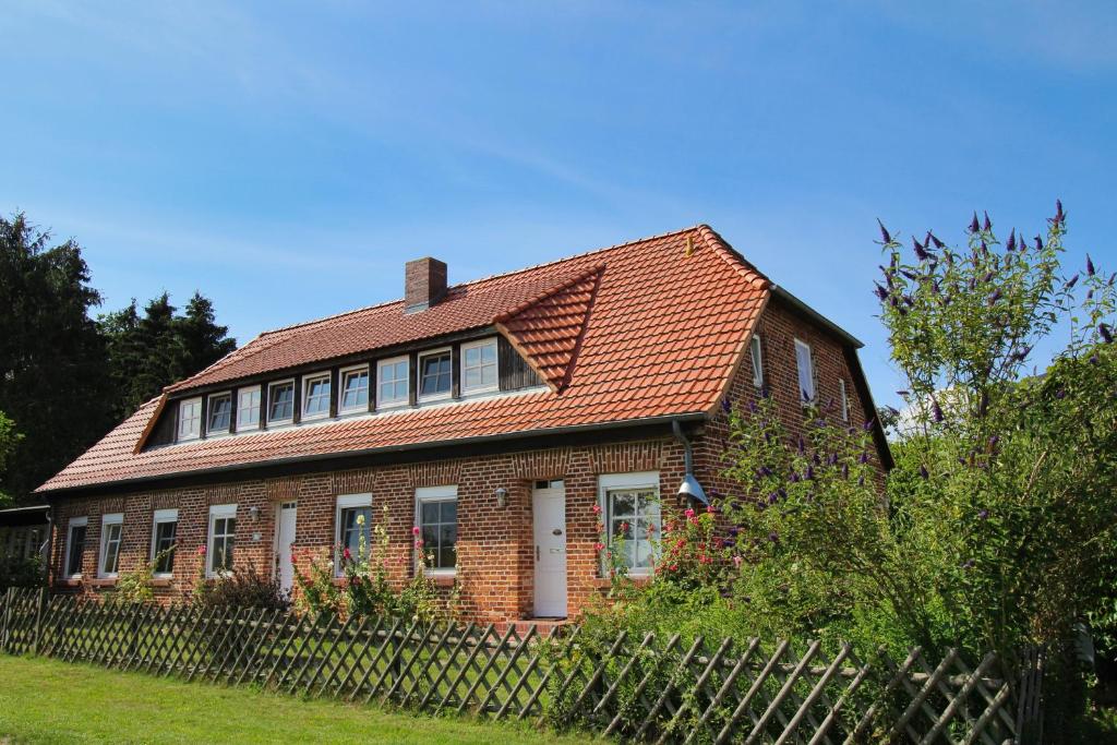 a brick house with a red roof at Ferienhaus Makrele von 1877 in Stahlbrode