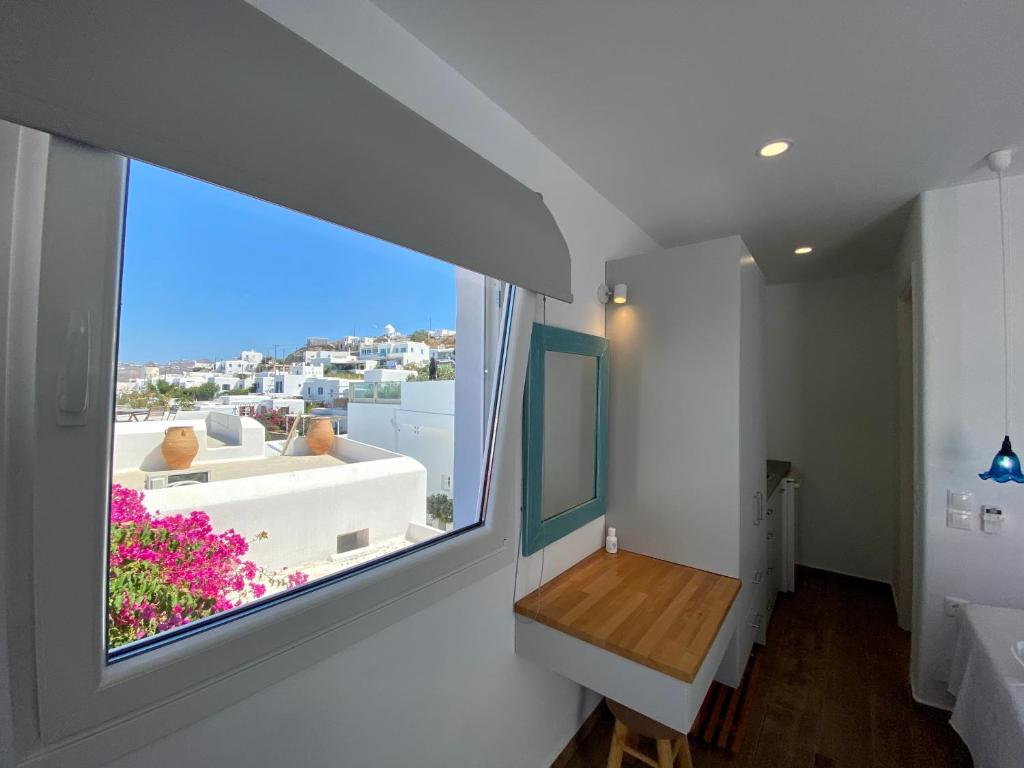 a room with a large window with a view at Maria Elena - Suite Home in Mýkonos City