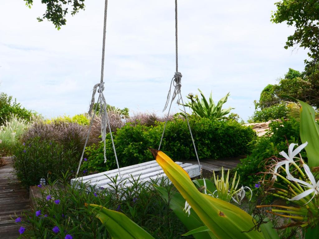 a swing in the middle of a garden at Vimarn Samed Resort in Ko Samed