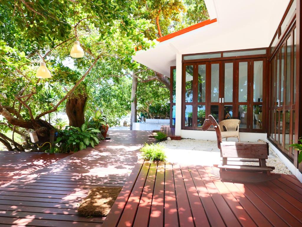 a wooden deck with a bench on a house at Vimarn Samed Resort in Ko Samed