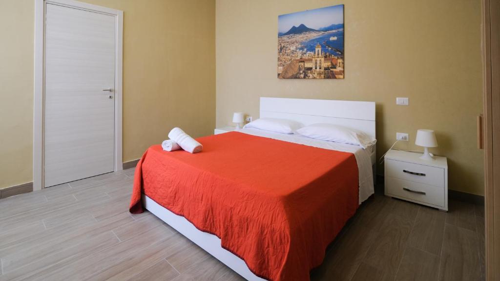 a bedroom with a large bed with a red blanket at Royal Dante in Naples
