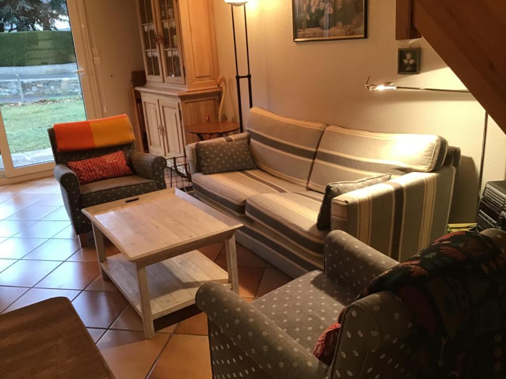 a living room with a couch and chairs and a table at Tourmalet Home in Luz-Saint-Sauveur