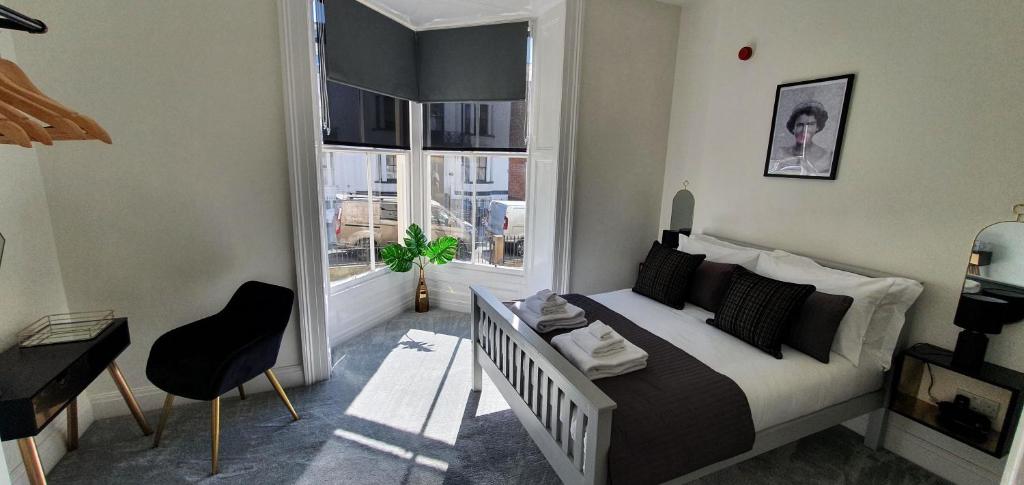 a bedroom with a bed and a large window at Spa House Retreat in Whitby