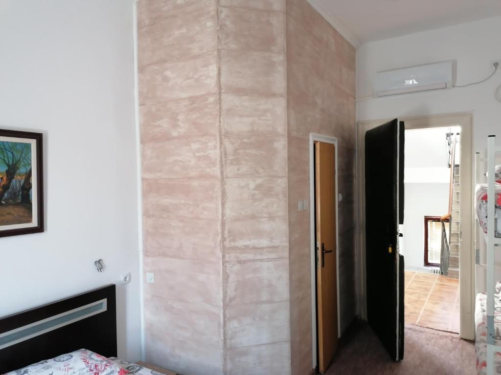 a room with a stone wall with a fireplace at Exit Labirint Centar in Novi Sad