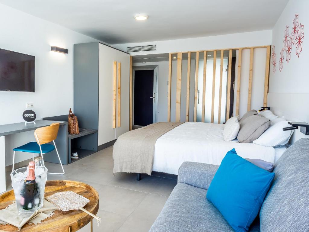 a bedroom with a bed and a couch at Hotel Taimar in Costa Calma