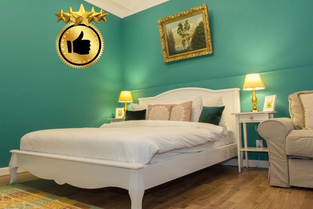 a bedroom with a white bed and a chair at Premium Studio by MRG Apartments in Bucharest