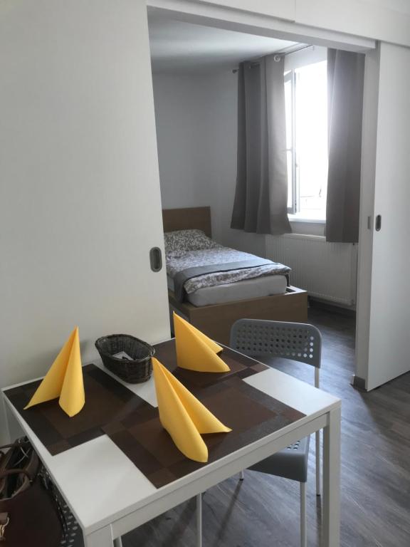 a room with a table with yellow objects on it at LG nicely Apartment in Korneuburg