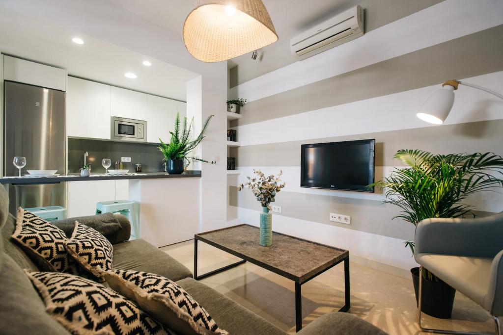 a living room with a couch and a table at Magno Apartments Encarnación in Seville