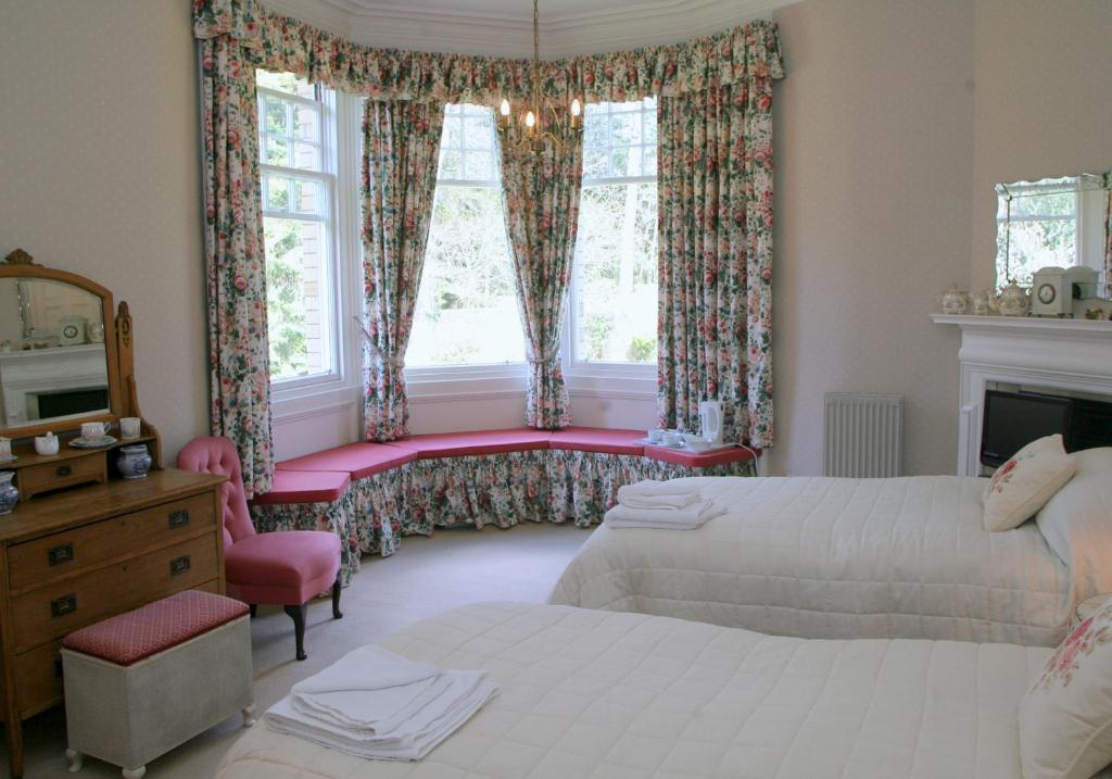 a bedroom with two beds and a window at Kirklands House Melrose Bed and Breakfast in Melrose