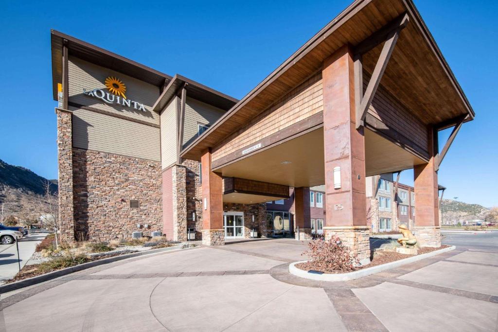 a building with a sign on the front of it at La Quinta by Wyndham Durango in Durango