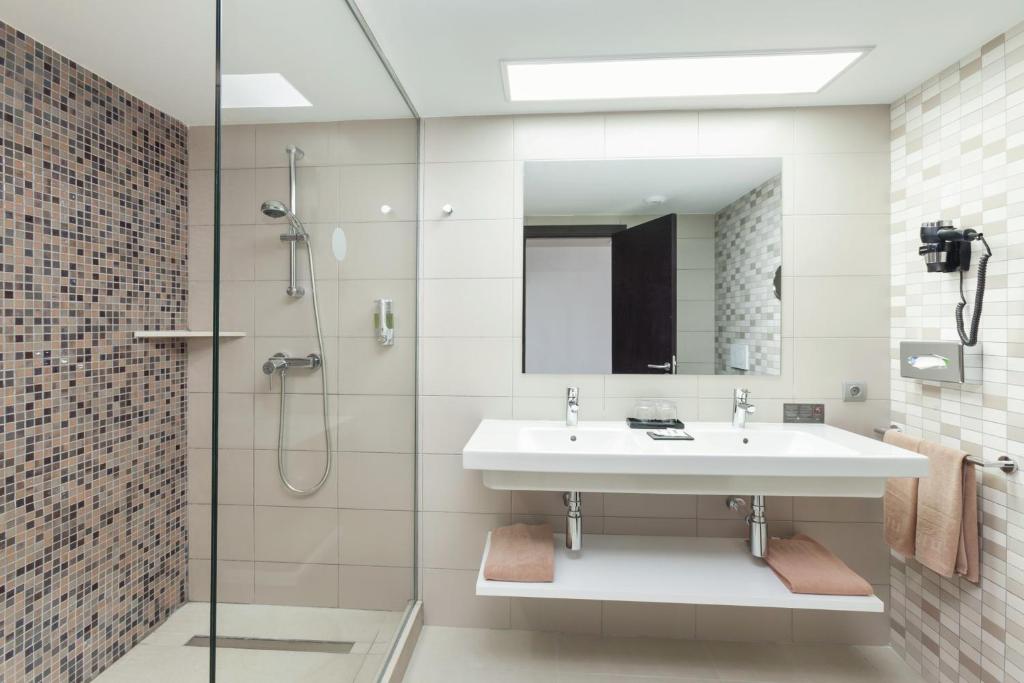 a bathroom with a sink and a shower at Hotel Riu Costa del Sol - All Inclusive in Torremolinos