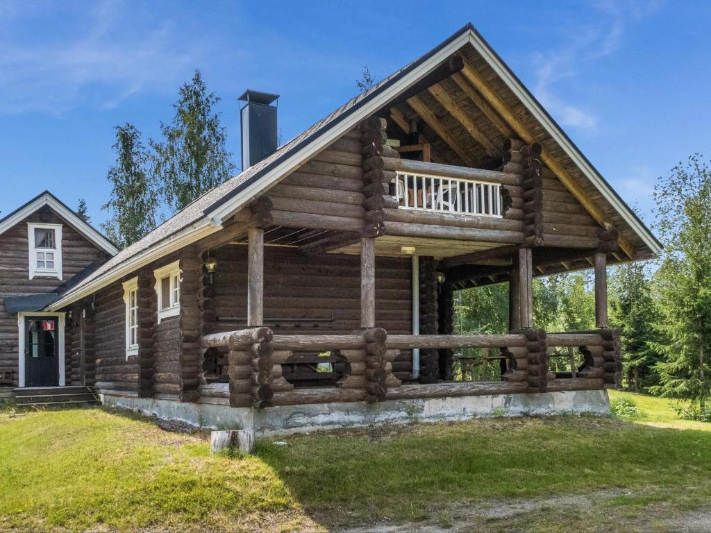 a log cabin with a porch and a deck at Holiday Home Vuokatticottage c by Interhome in Vuokatti