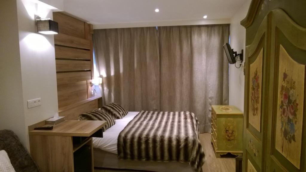 Postel nebo postele na pokoji v ubytování Hôtel Vallée Blanche