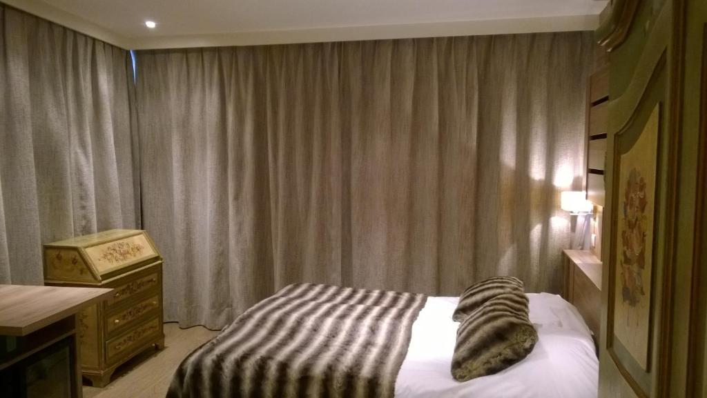Postel nebo postele na pokoji v ubytování Hôtel Vallée Blanche