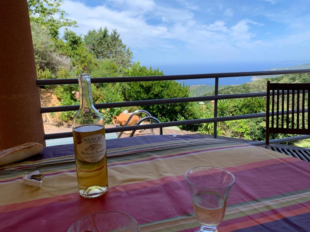 a bottle of beer sitting on a table on a balcony at Villa Confina in Villanova