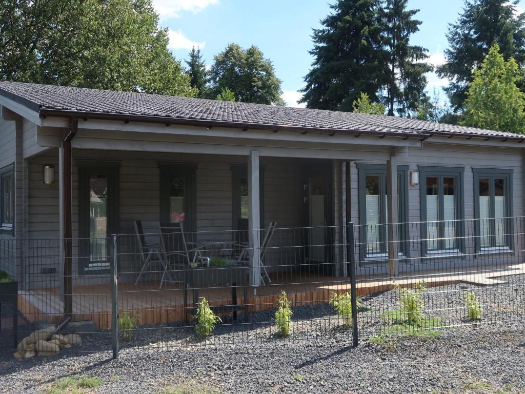 a small house with a fence around it at Holiday Home Ferienhaus Barbara by Interhome in Enspel
