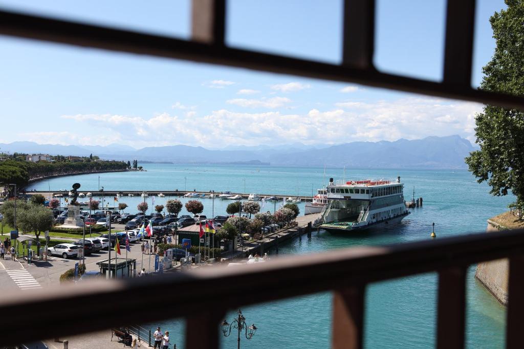 a view of a harbor with a boat in the water at Hotel Bell'arrivo by Dori in Peschiera del Garda