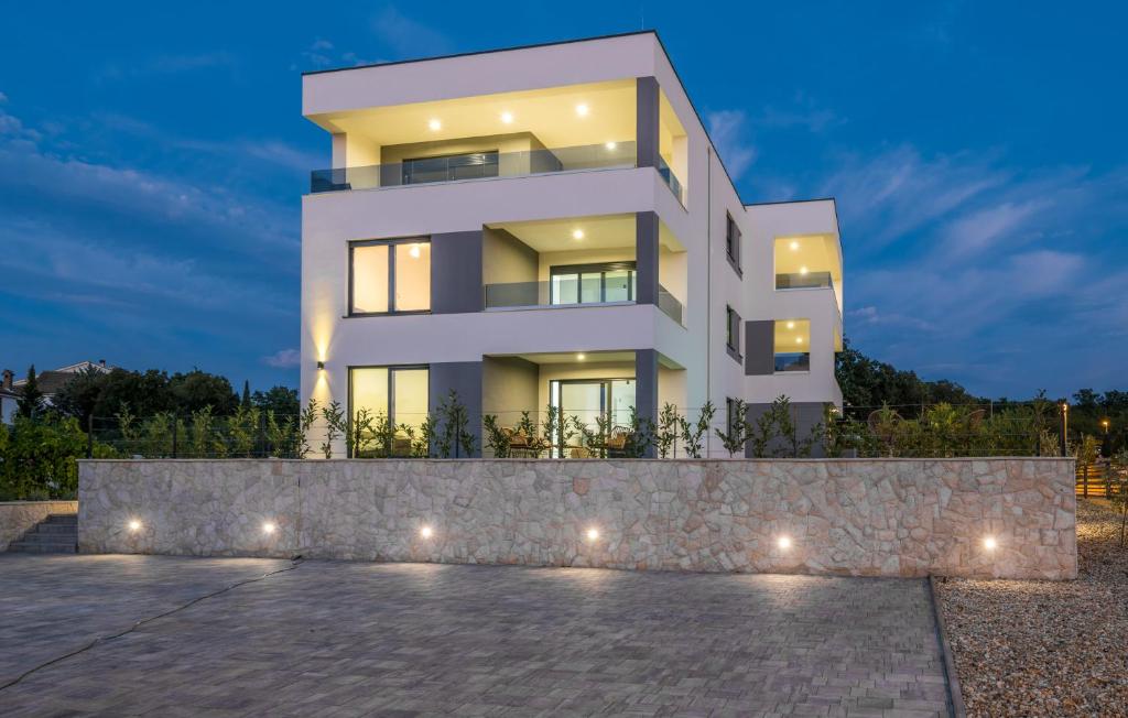a white house with lights in front of it at VILA STEMARK in Njivice