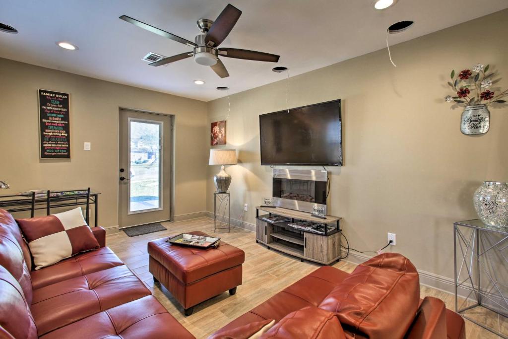 a living room with a couch and a flat screen tv at Contemporary NOLA Home - Walk to City Park! in New Orleans