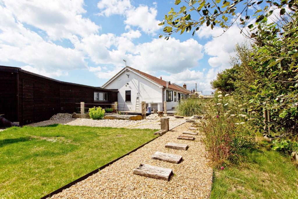 a backyard with a house and a yard with a pathway at Big Sky in Camber