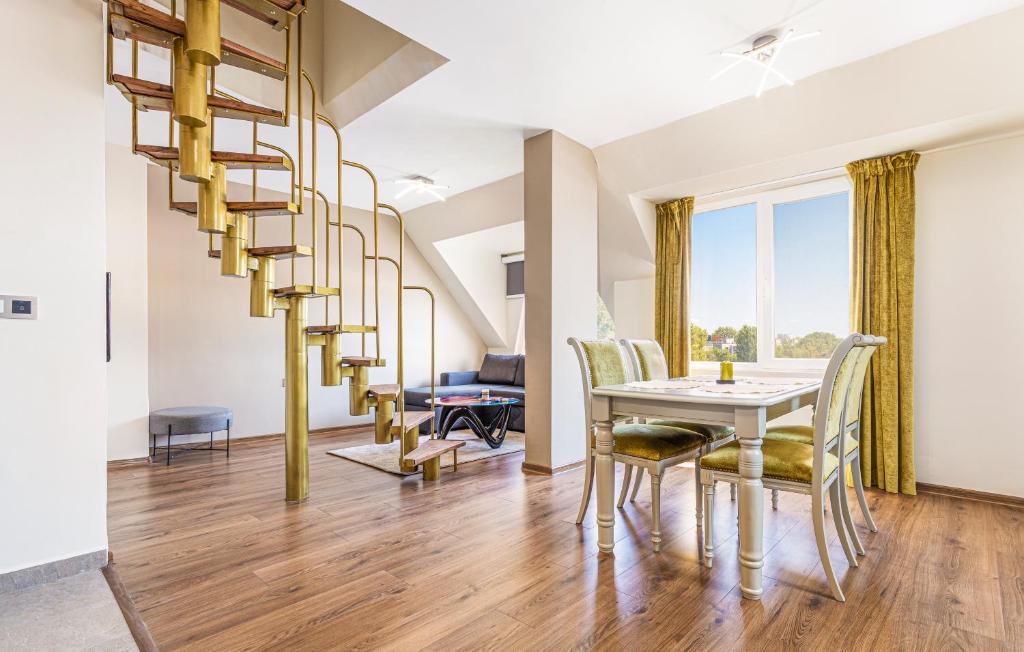 a dining room with a spiral staircase and a table and chairs at Fancy 1BD penthouse with terrace near the centre in Plovdiv