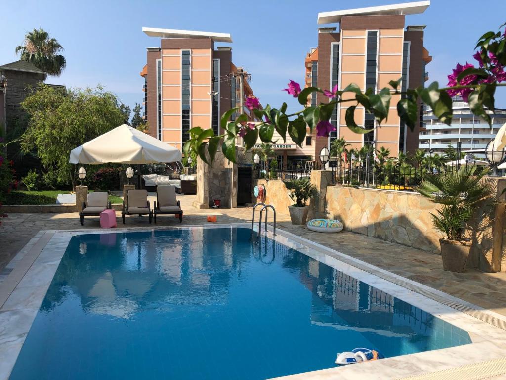 a pool at a hotel with buildings in the background at Dreamhome in Alanya
