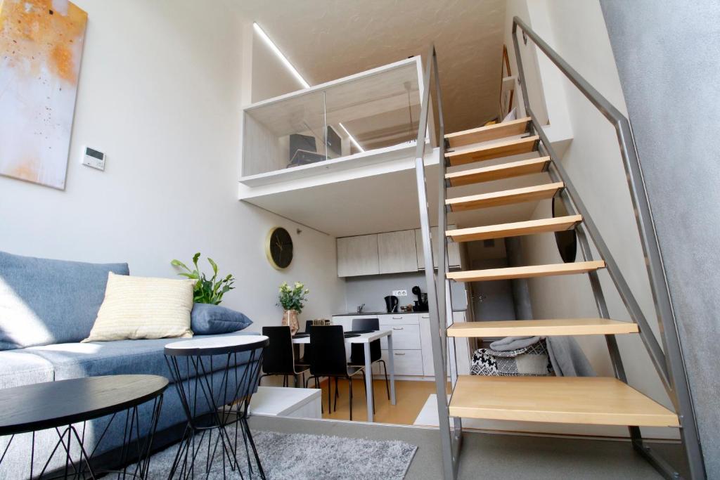 un petit appartement avec un escalier et un salon dans l'établissement Vita Sana Apartments&SPA, à Zlín