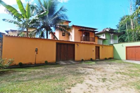 a house with a palm tree in front of it at Casa Vila Dom Pedro in Paraty