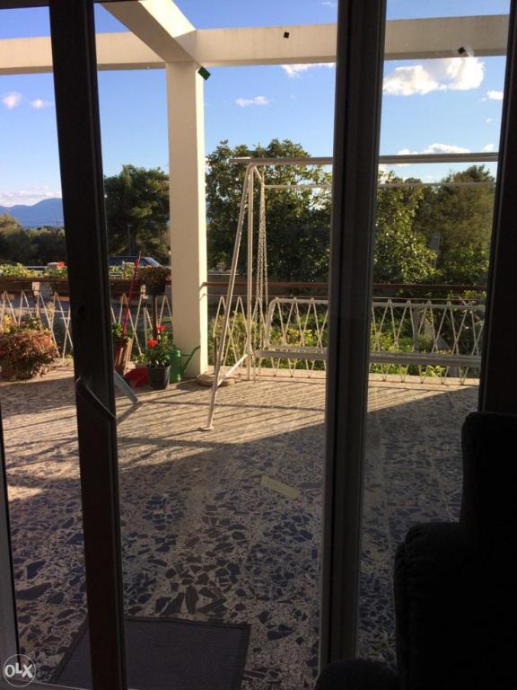 a view of a playground through a sliding glass door at Apartments Medici in Zaostrog