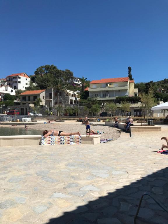 a group of people laying on towels on a beach at studio apartment near the beach-Ilda Radonic in Jelsa