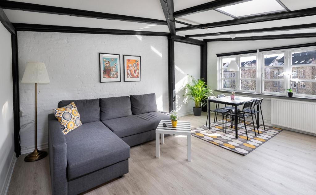 a living room with a couch and a table at aday - Apartment suite 4 Aalborg Center in Aalborg