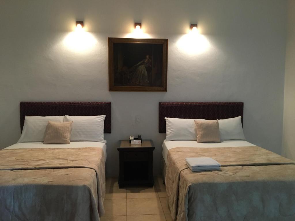 Postel nebo postele na pokoji v ubytování Hotel Mejorada Merida