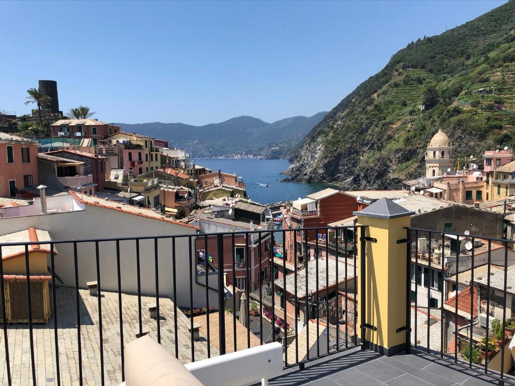 a view from a balcony of a town and a river at La Polena Camere Vernazza - Suite vista mare in Vernazza