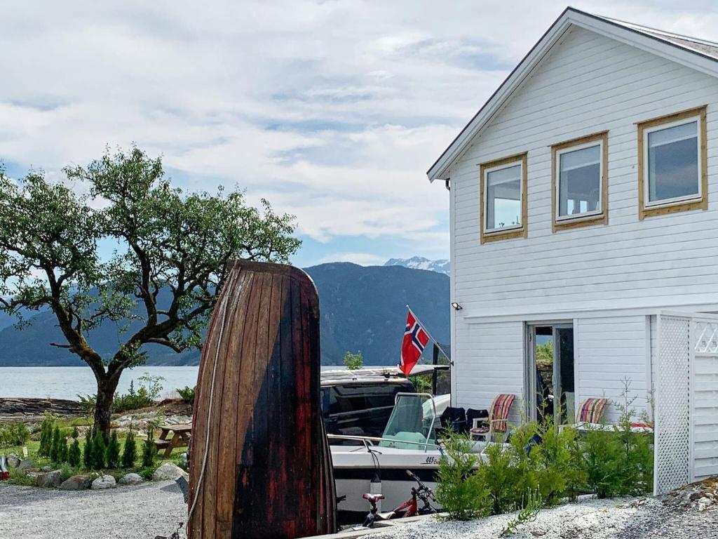 a house and a boat in front of a house at Holiday home TØRRVIKBYGD in Tyrvikbygd