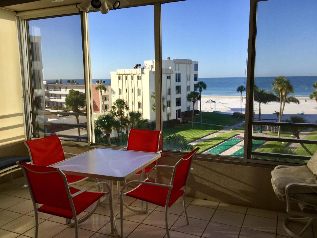 a table and chairs in a room with a view of the beach at Island House Beach Resort 16N in Siesta Key