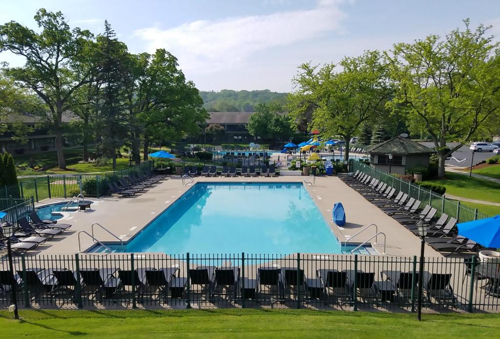 a large swimming pool with chairs and tables at The Abbey Resort in Lake Geneva