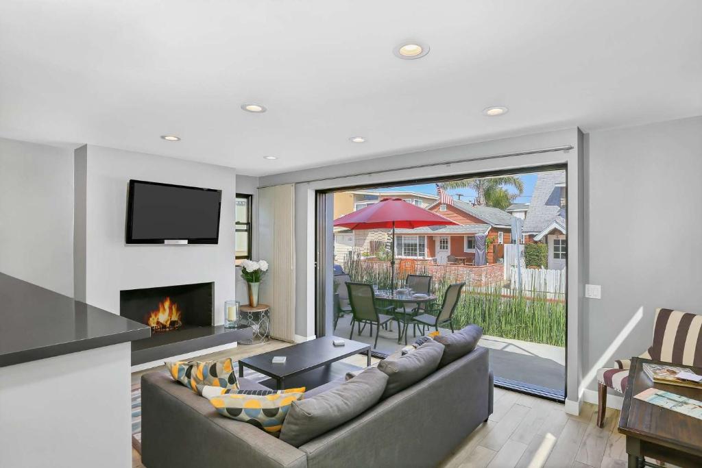 a living room with a couch and a fireplace at 308 35th Street, Unit A (Lower) in Newport Beach