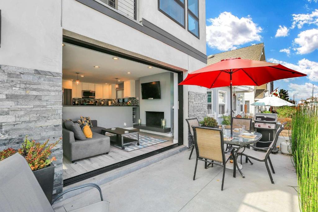 a patio with a table and a red umbrella at 308 35th Street, Unit A (Lower) in Newport Beach