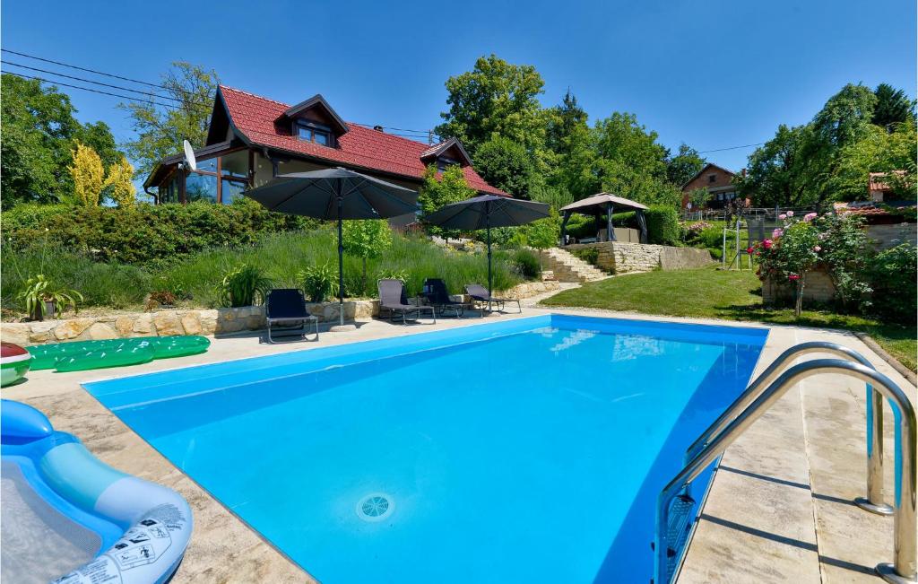 a swimming pool in front of a house at Beautiful Home In Seketin With Sauna in Seketin