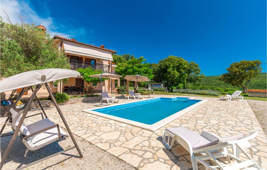 a villa with a swimming pool and a house at Stunning Home In Labin With Outdoor Swimming Pool in Labin