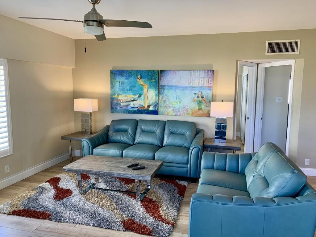 a living room with a blue couch and a table at Island House Beach Resort 12S in Point O'Rocks