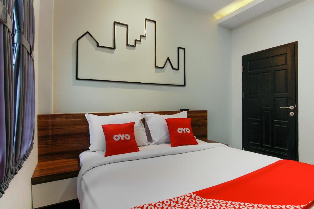 Postel nebo postele na pokoji v ubytování Capital O 3476 Millenium Inn