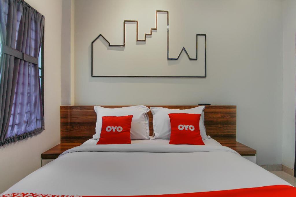 Postel nebo postele na pokoji v ubytování Capital O 3476 Millenium Inn