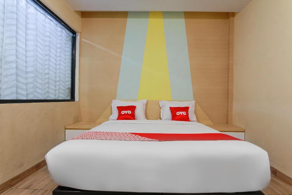 Postel nebo postele na pokoji v ubytování Capital O 3476 Millenium Inn