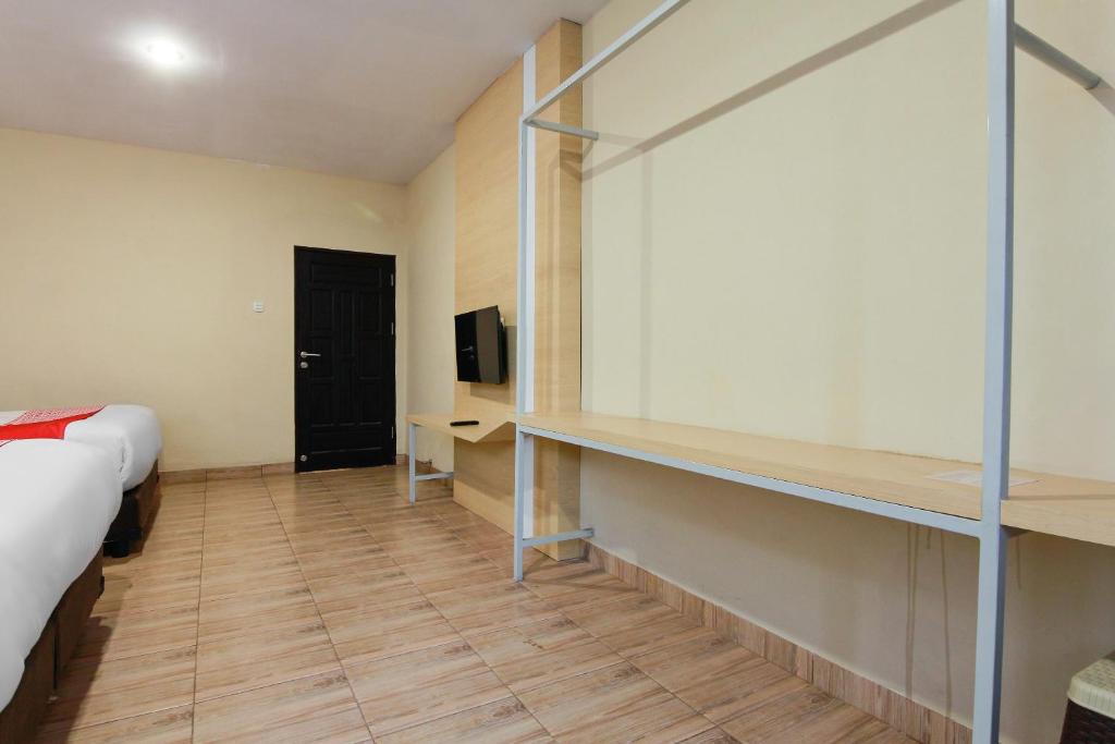 Postel nebo postele na pokoji v ubytování Capital O 3476 Millenium Inn
