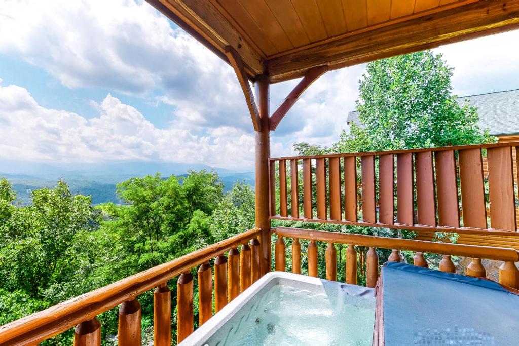 a hot tub on a deck with a view of the mountains at The Sweet Escape in Sevierville