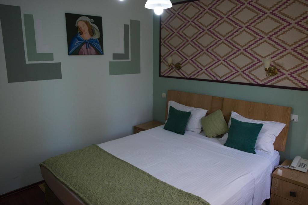 Postel nebo postele na pokoji v ubytování Hotel Michelangelo