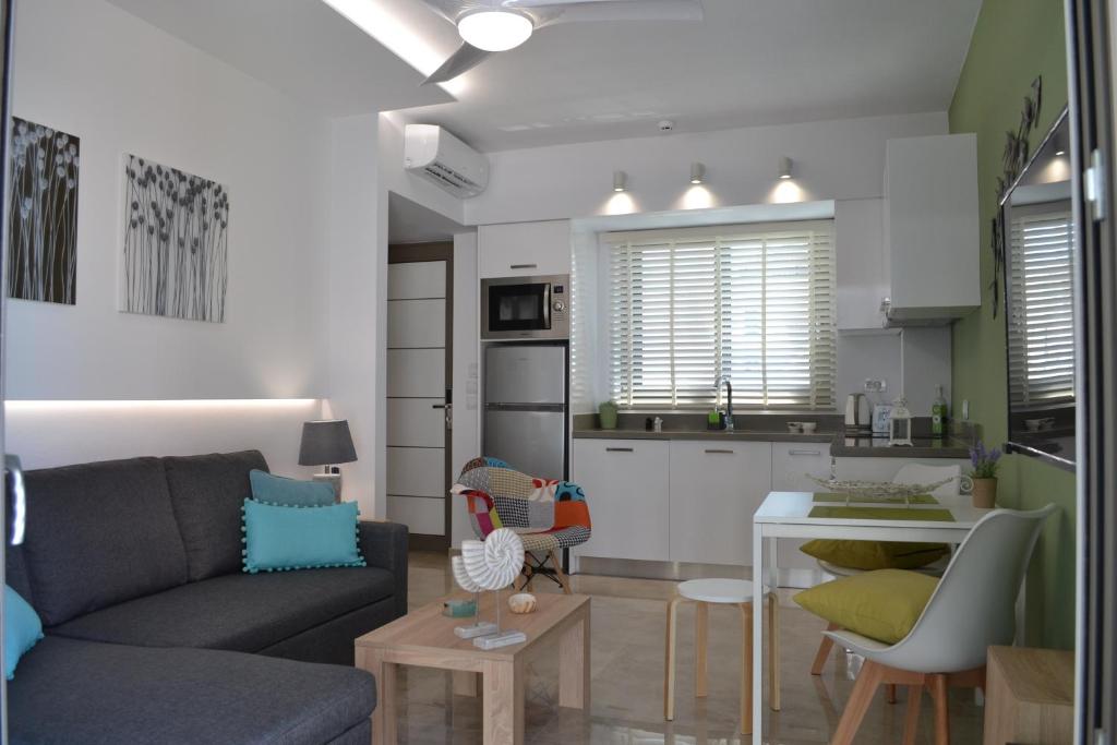 a living room with a couch and a kitchen at Filia Luxury Apartments in Chania Town